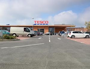 view of the outside of tesco and some of its car park 